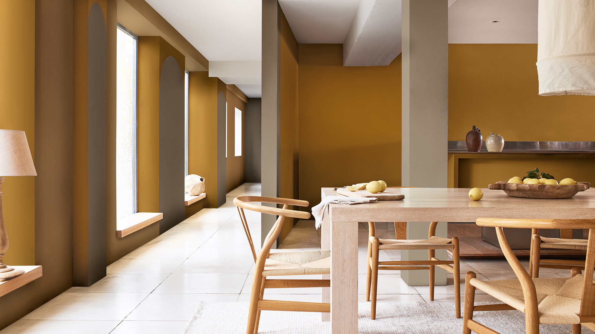 Open plan dining room with wooden table and tall windows on left-hand side Dulux_CF21_how-to_arch_dining room with windows_Global_5